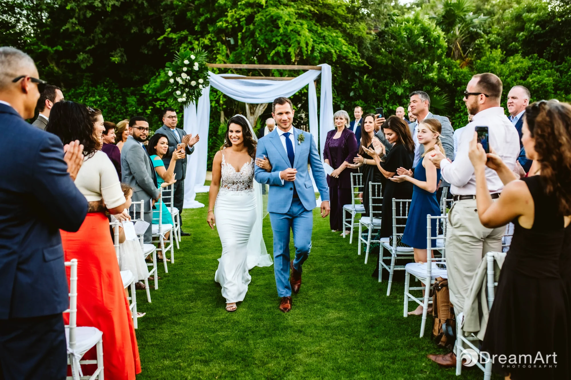 Newlyweds walk down the aisle at a Riviera Maya beach wedding.