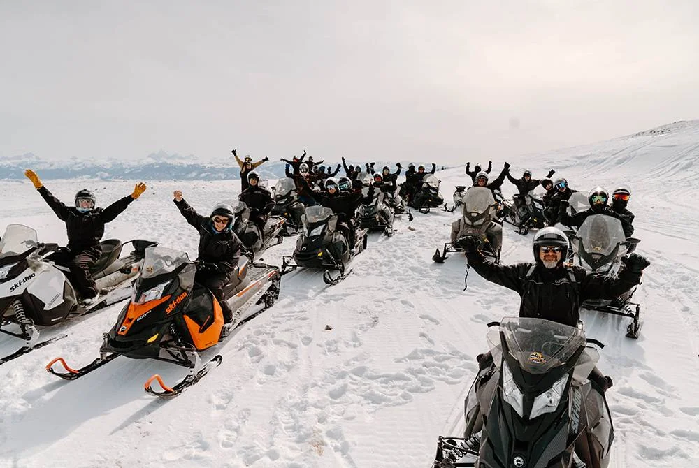 Group of snowmobilers celebrating in Jackson Hole, Wyoming
