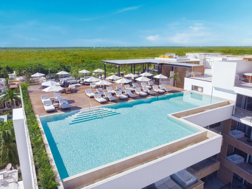 Luxury rooftop pool and lounge area at The Fives Oceanfront, a stunning wedding destination.