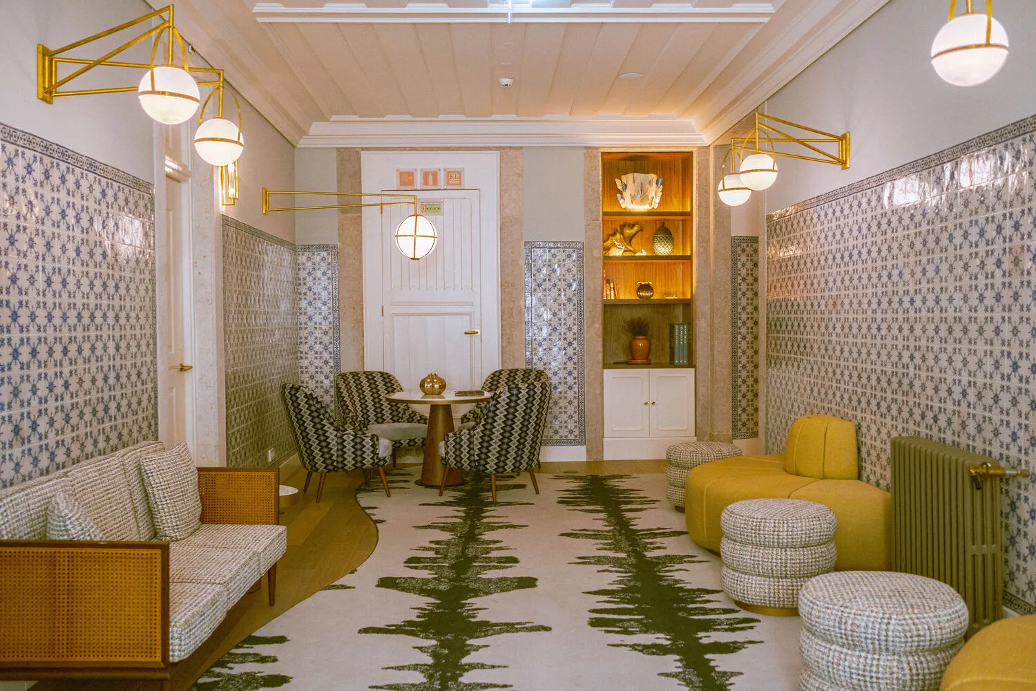Elegant lounge area at the Palácio Ludovice Hotel, featuring comfortable seating and patterned tile.