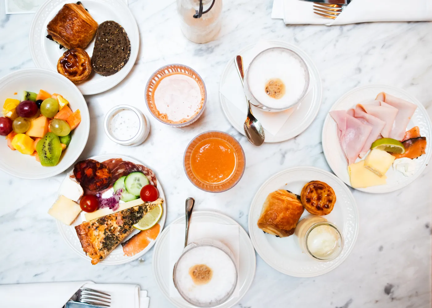 Lavish breakfast spread at Palácio Ludovice Hotel featuring pastries, fruit, cheese, and coffee.