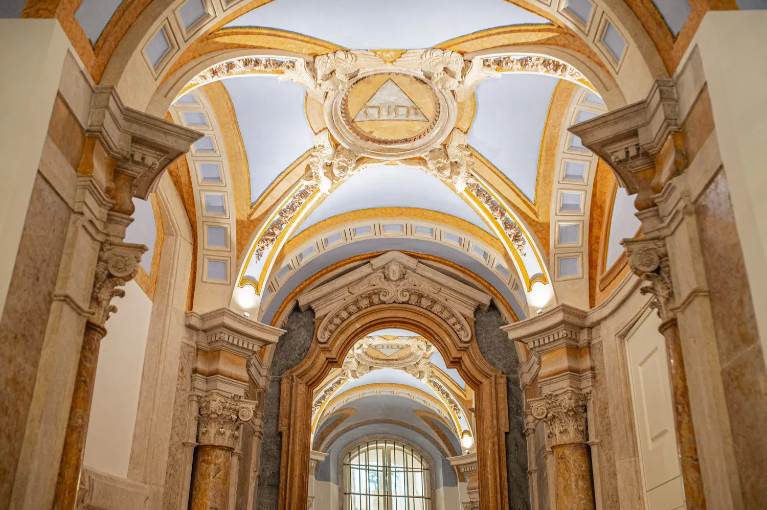 Ornate hallway ceiling and columns at the Palácio Ludovice.