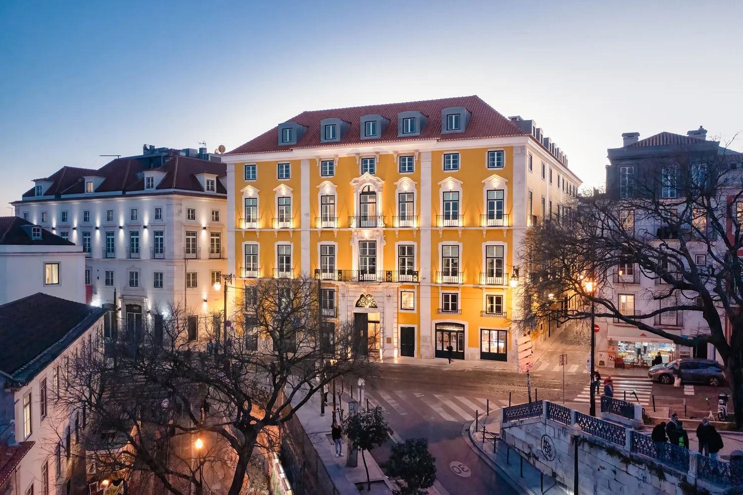 Exterior view of the Palácio Ludovice Hotel in Lisbon at dusk.