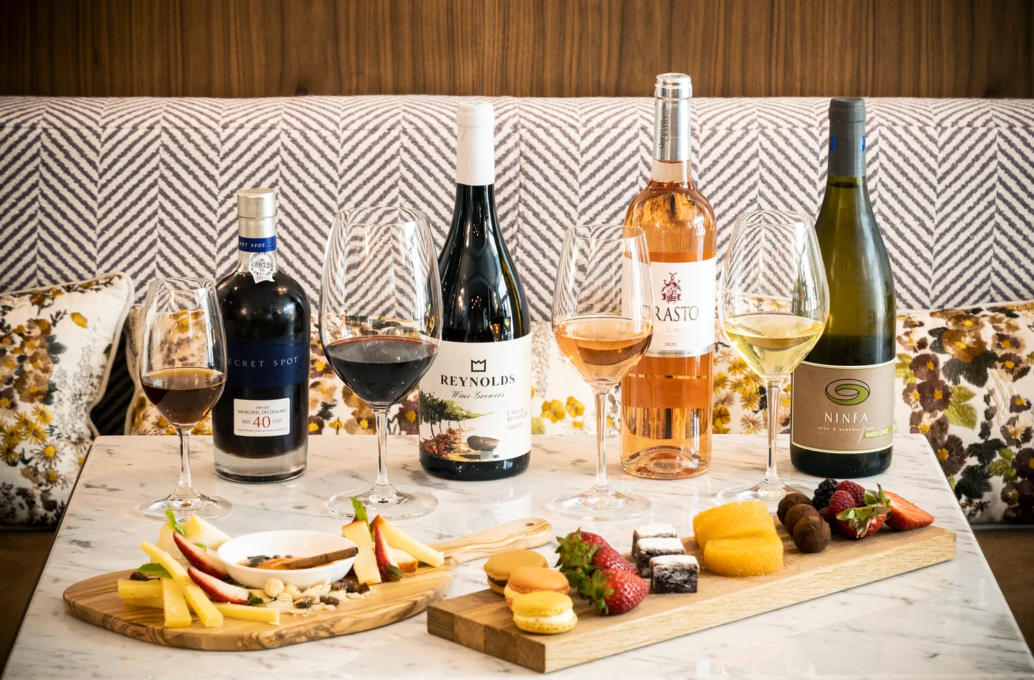 Wine tasting at Palácio Ludovice Hotel featuring various Portuguese wines and cheeses.