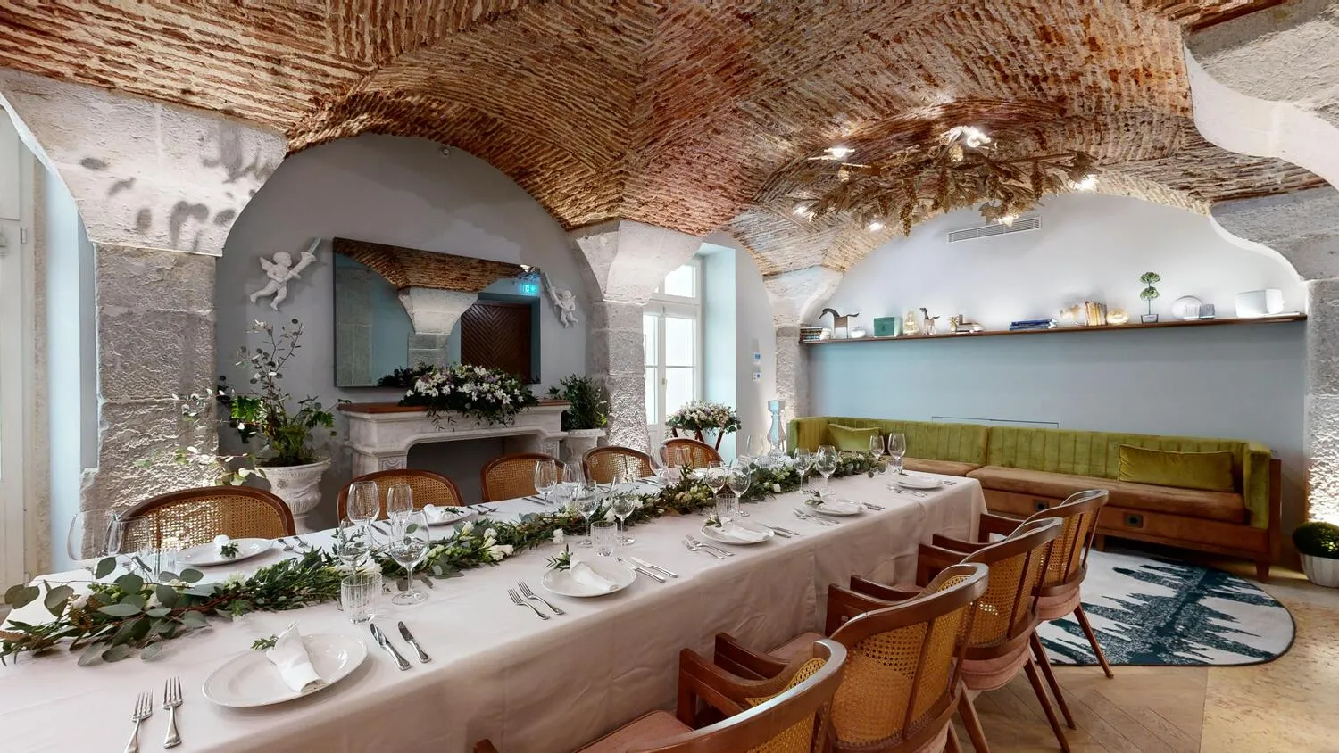 Elegant dining room at Palácio Ludovice Hotel, featuring a long table set for a meal.