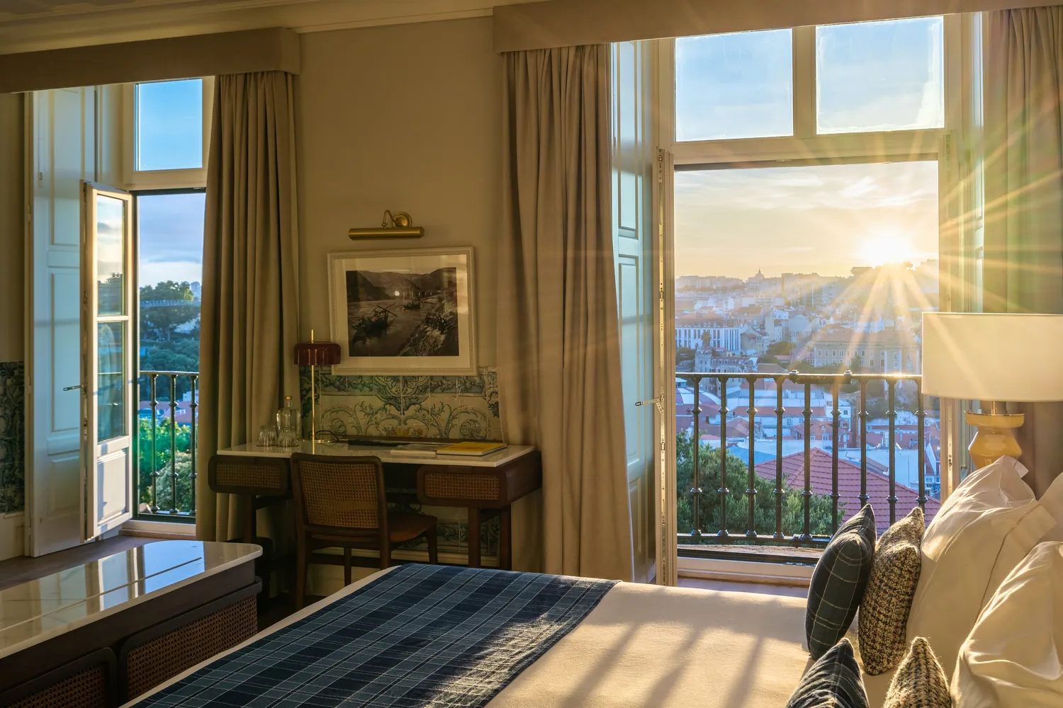 Sunrise view from a Palácio Ludovice hotel room, overlooking Lisbon rooftops.