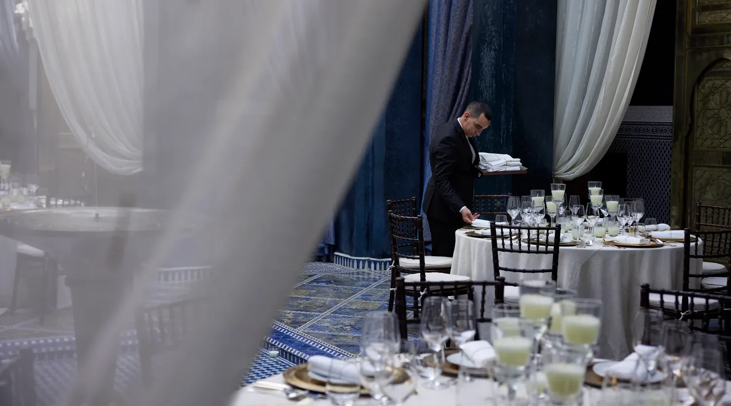 Waiter setting tables for a luxurious event at the Royal Mansour Marrakech.