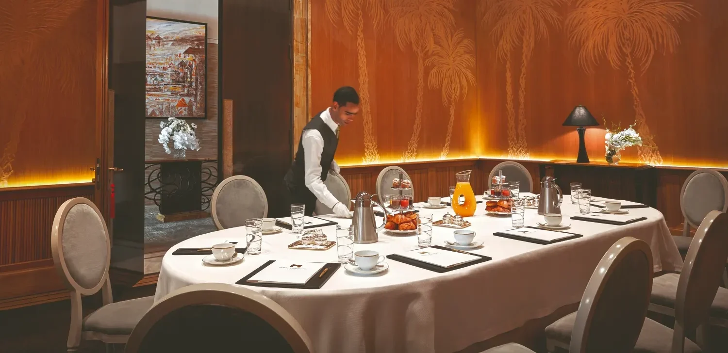 Waiter setting a table for a private breakfast or meeting at the Royal Mansour Marrakech.