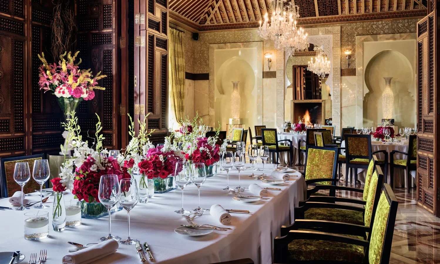 Elegant dining room at Royal Mansour Marrakech, set for a celebration with floral centerpieces.