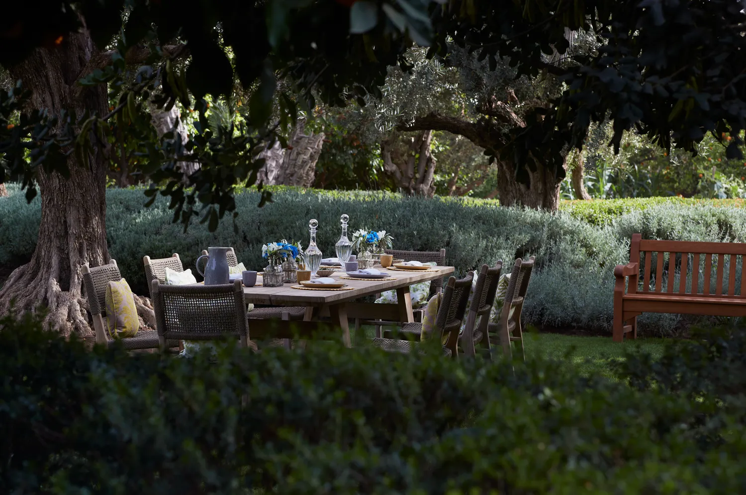 Outdoor dining table set for a celebration at Royal Mansour Marrakech, surrounded by lush greenery.