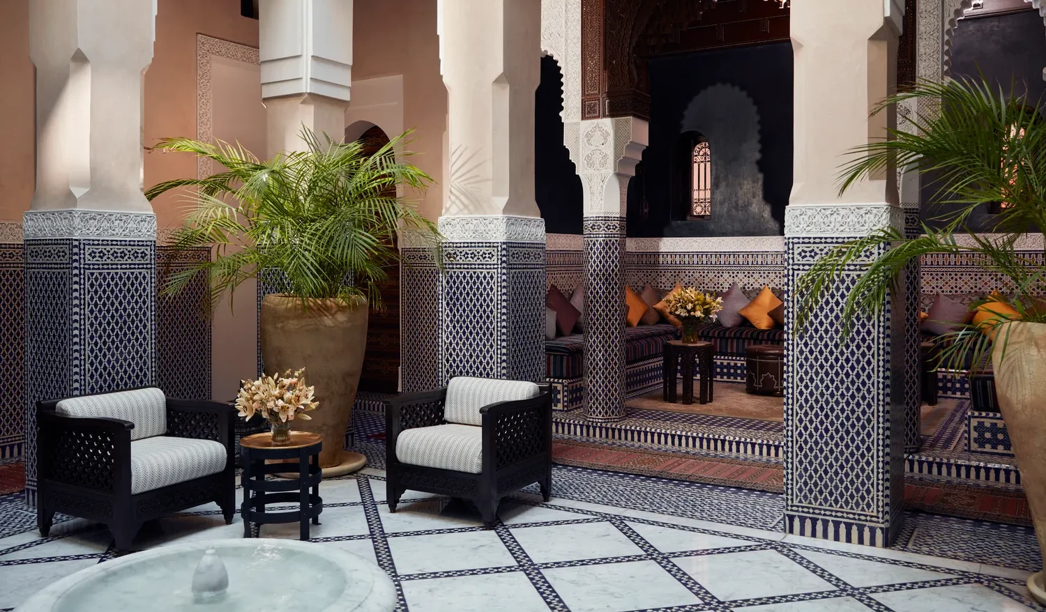 Ornate courtyard at Royal Mansour Marrakech, featuring plush seating and intricate tilework.
