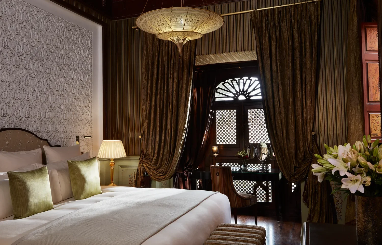Luxurious Royal Mansour Marrakech bedroom with ornate details and comfortable bedding.