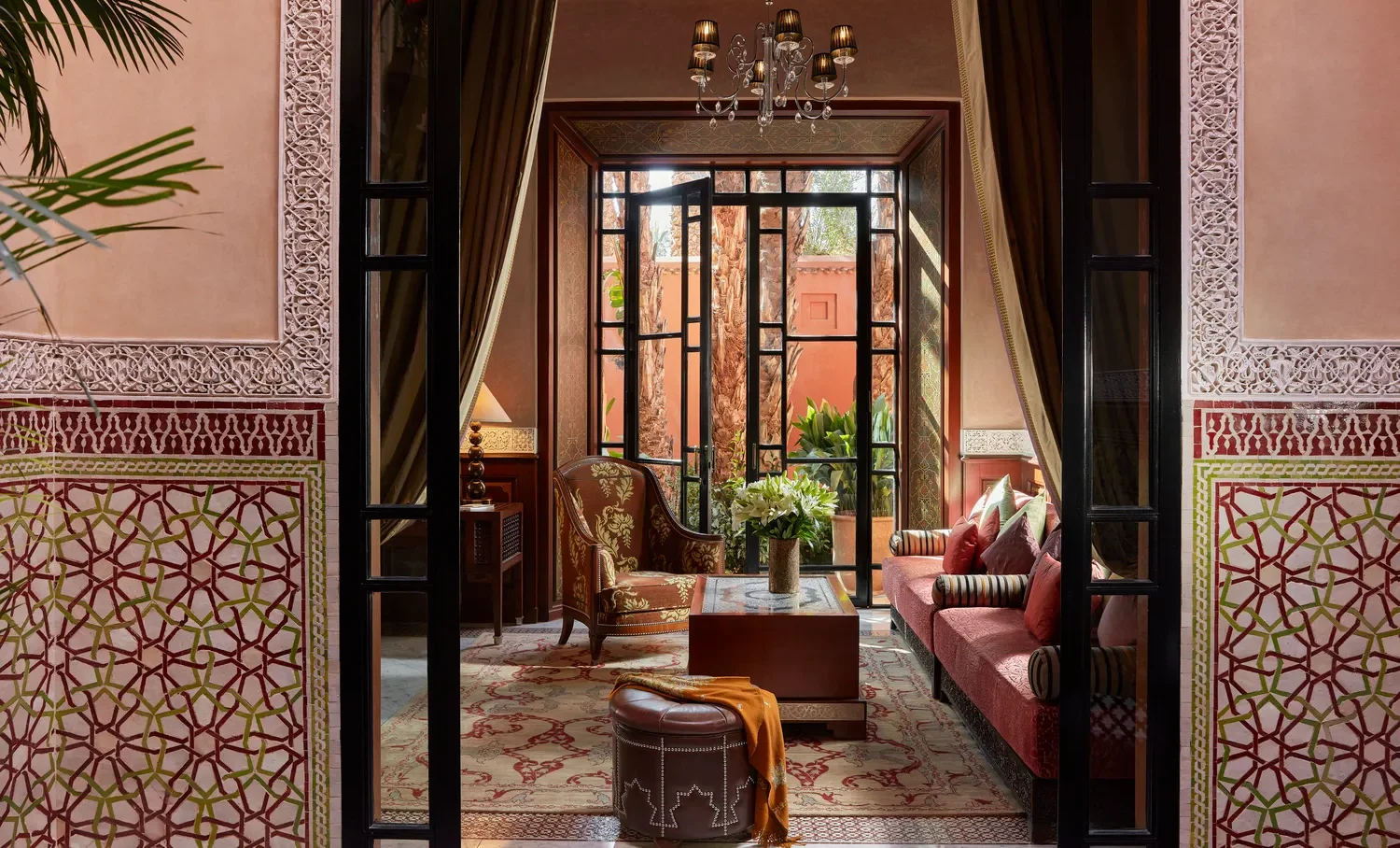 Luxurious Moroccan living room at Royal Mansour Marrakech, featuring ornate tilework and comfortable seating.
