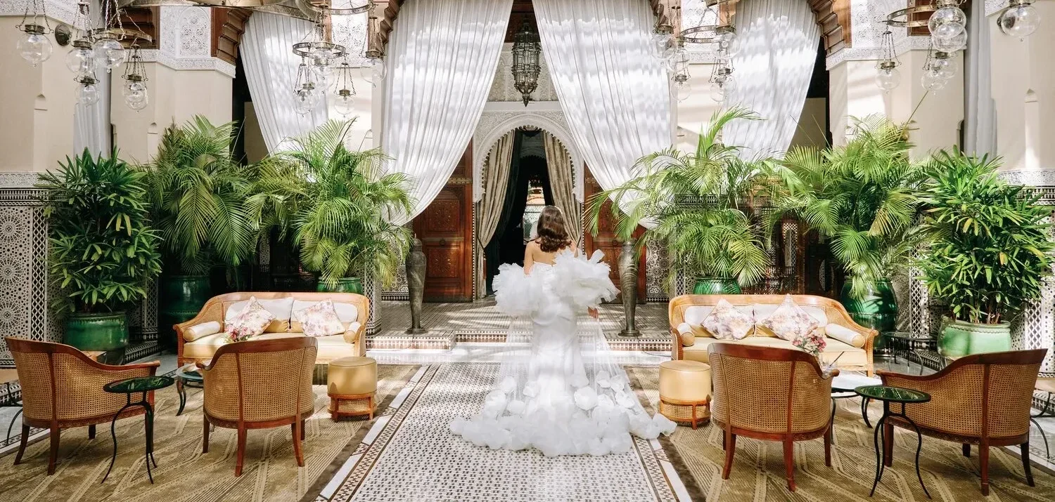 Bride in a white gown at Royal Mansour Marrakech, celebrating in a luxurious courtyard.