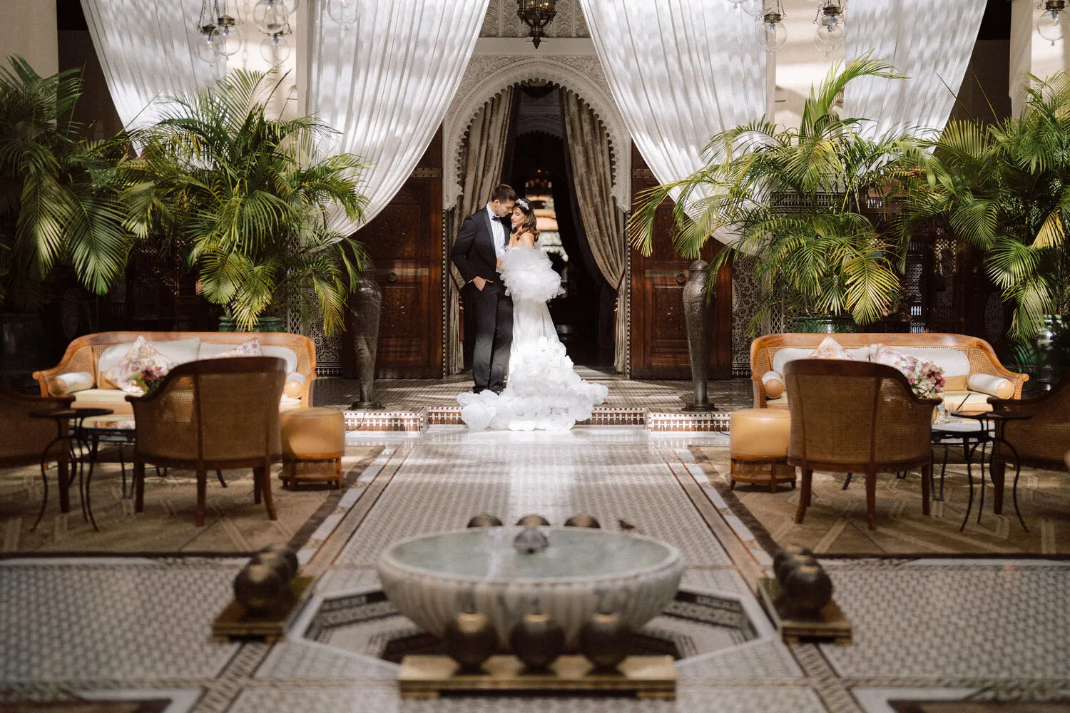 Bride and groom pose for wedding photos at the Royal Mansour Marrakech.