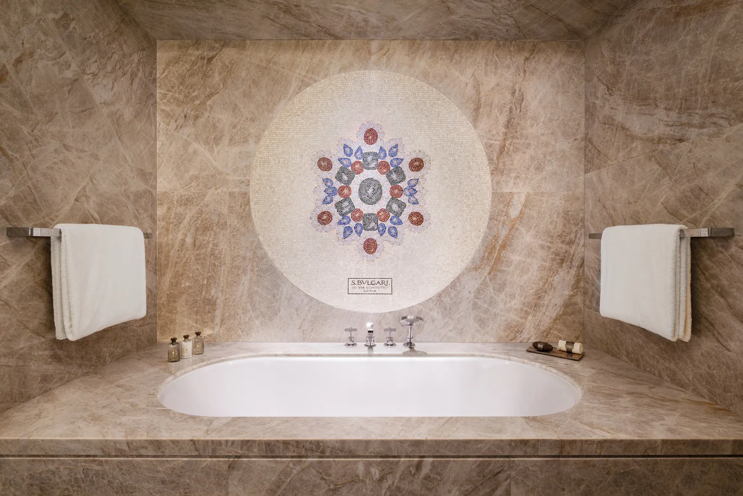 Luxury bathroom at the Bvlgari Hotel Roma, featuring a mosaic and freestanding tub.