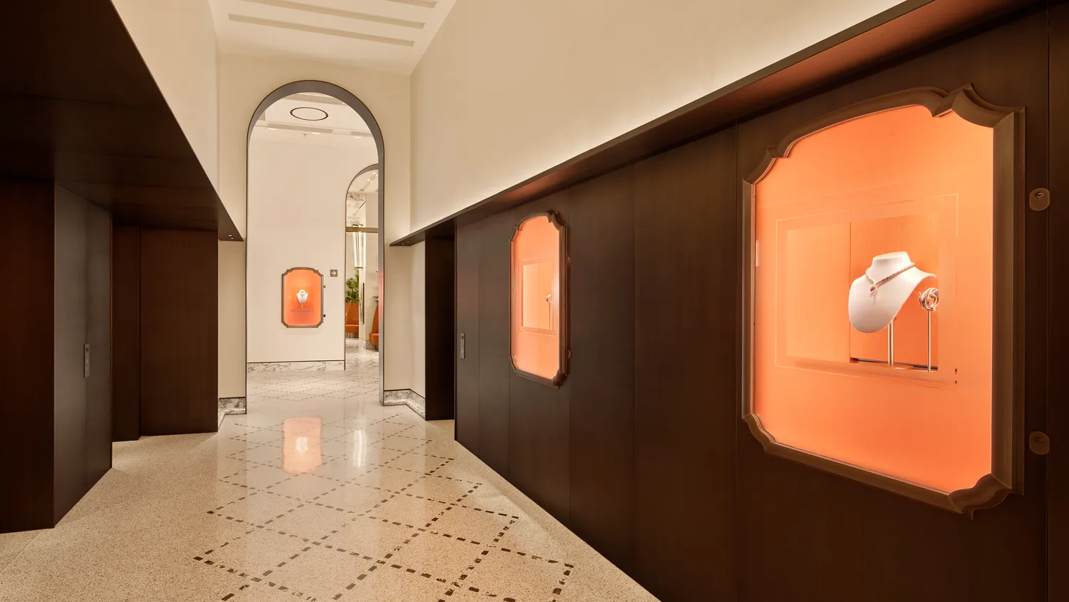 Elegant hallway at the Bvlgari Hotel Roma, showcasing exquisite jewelry displays.