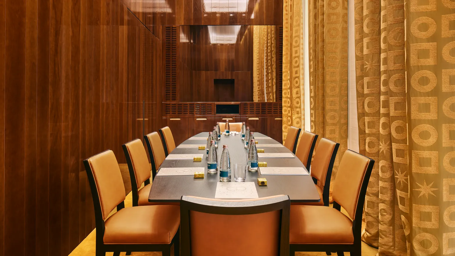 Elegant conference table set for a meeting at the Bvlgari Hotel Roma, perfect for weddings.