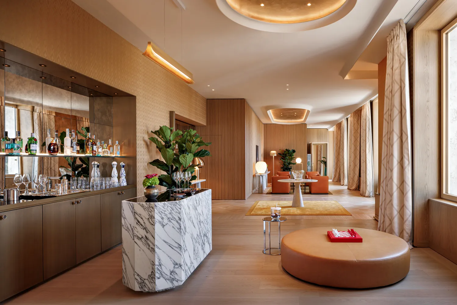Luxurious suite at the Bvlgari Hotel Roma, featuring a marble bar and seating area. Perfect for a wedding reception.