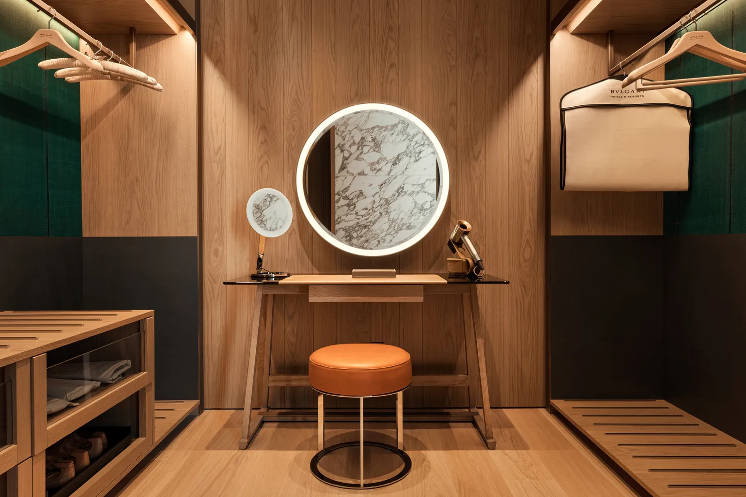 Luxury dressing area in Bvlgari Hotel Roma, featuring a vanity with a large round mirror.