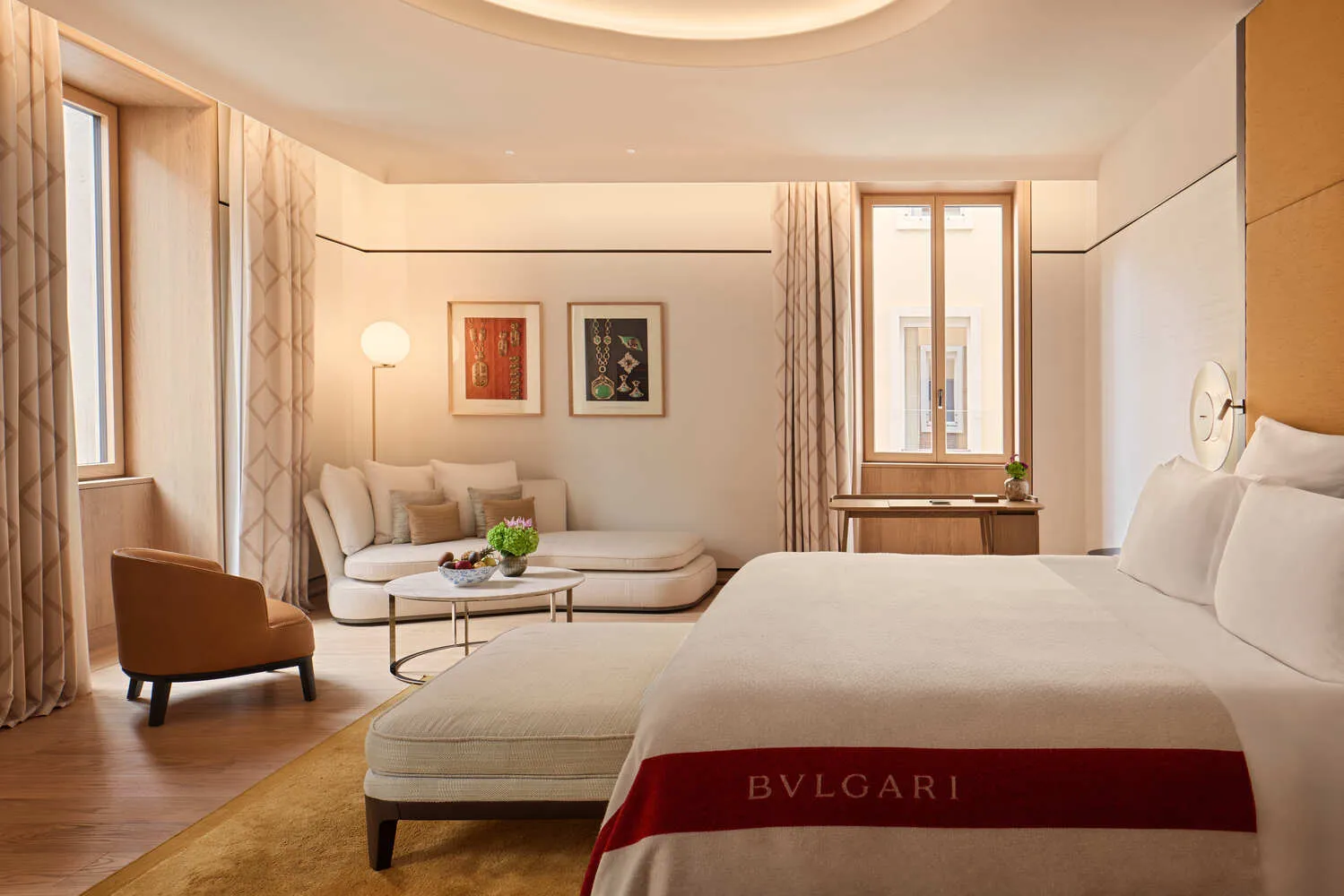 Luxurious Bvlgari Hotel Roma bedroom with king-size bed and sitting area.