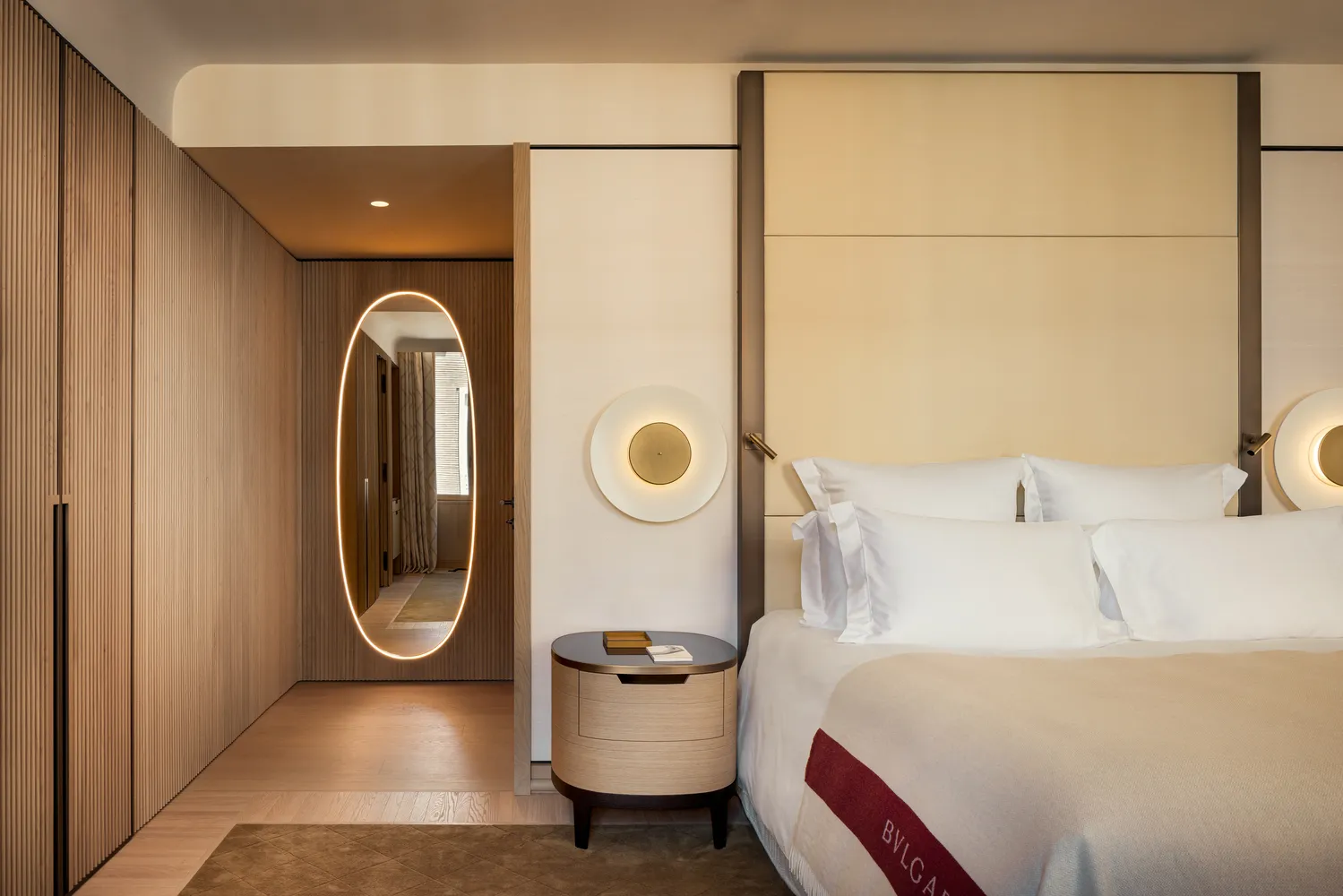 Luxurious bedroom at the Bvlgari Hotel Roma, featuring a plush bed and elegant decor.