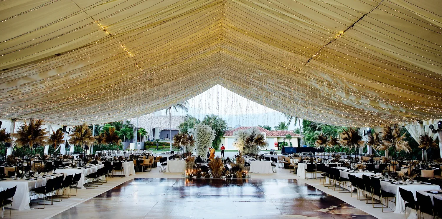 Elegant destination wedding reception at Marriott Puerto Vallarta, featuring a stunning tent and sophisticated decor.