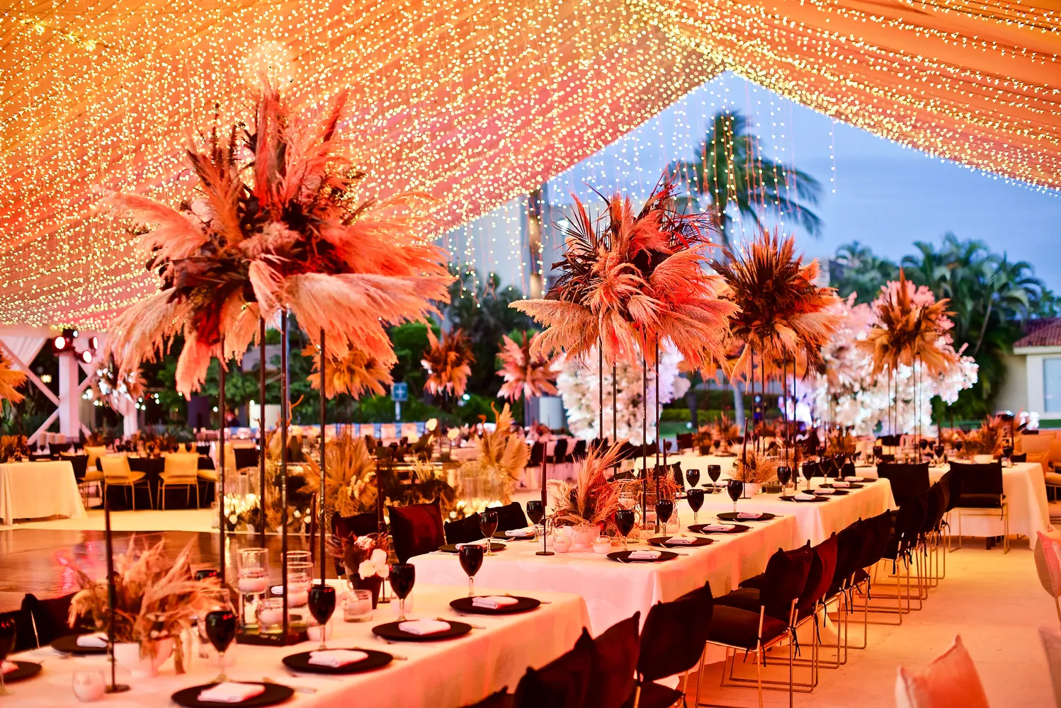 Elegant destination wedding reception at Marriott Puerto Vallarta, featuring pampas grass centerpieces.