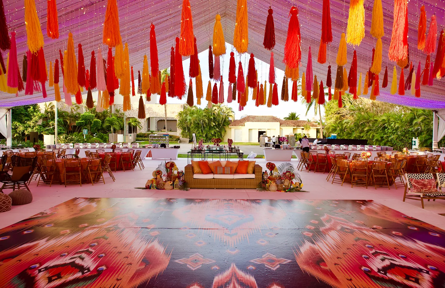 Vibrant destination wedding reception at Marriott Puerto Vallarta, featuring colorful tassels and patterned dance floor.