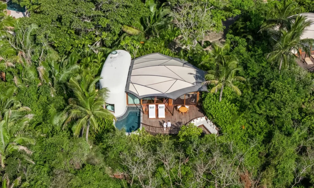 Aerial view of luxury jungle villa with private pool and deck