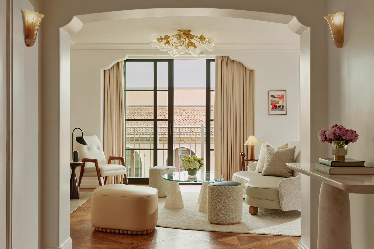 Luxurious living room at the Maybourne Beverly Hills, featuring a plush sofa and city views.