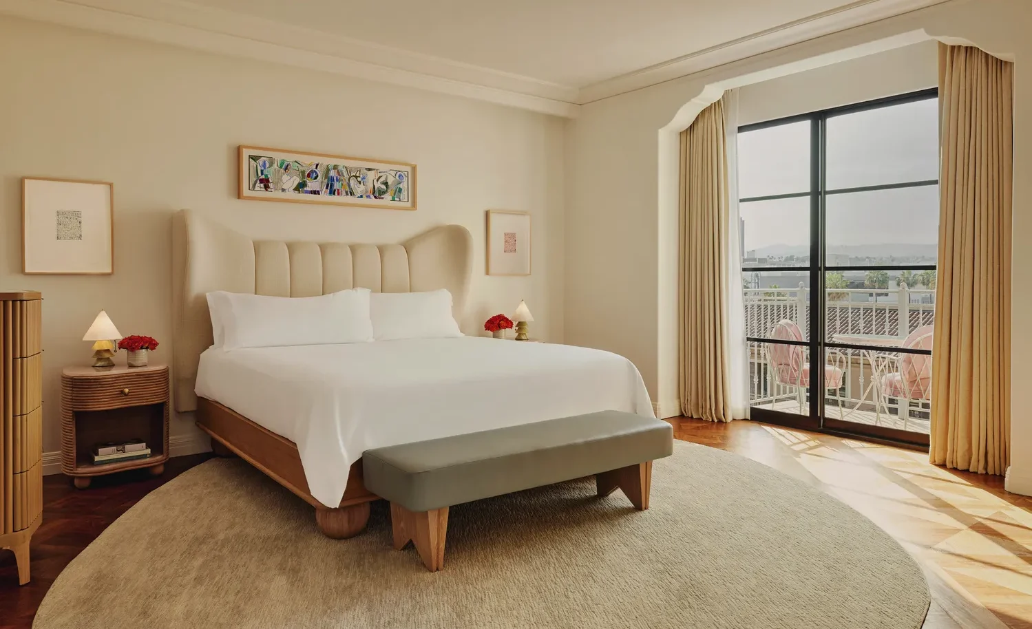 Luxurious bedroom at the Maybourne Beverly Hills, featuring a king-size bed and a private balcony overlooking the city. Ideal Beverly Hills wedding venue.