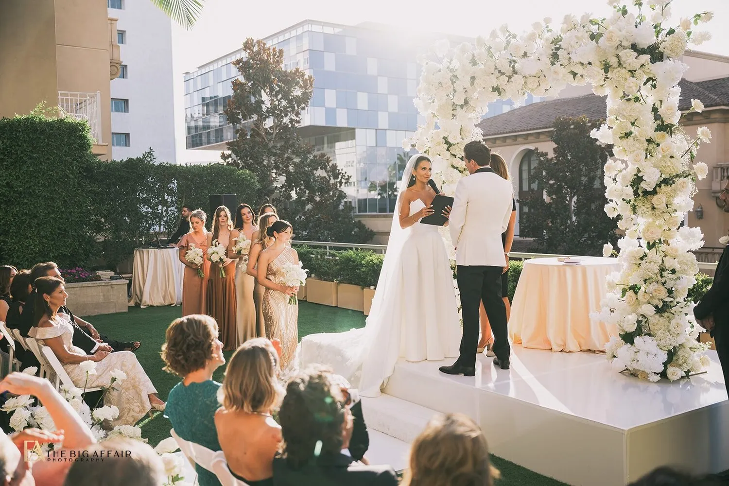 Bride and groom exchanging vows at a beautiful outdoor wedding ceremony at the Maybourne Beverly Hills, a luxurious Beverly Hills wedding venue.