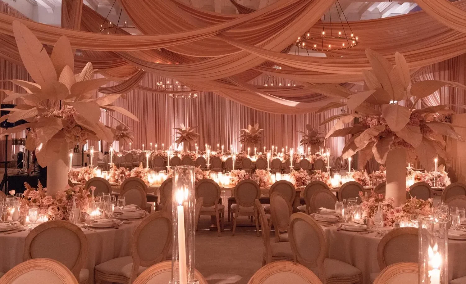 Elegant wedding reception at the Maybourne Beverly Hills, featuring candlelit tables and blush-toned decor.