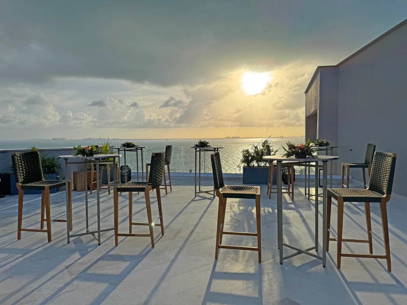 Sunset view from Almare Isla Mujeres rooftop with wedding-style seating.