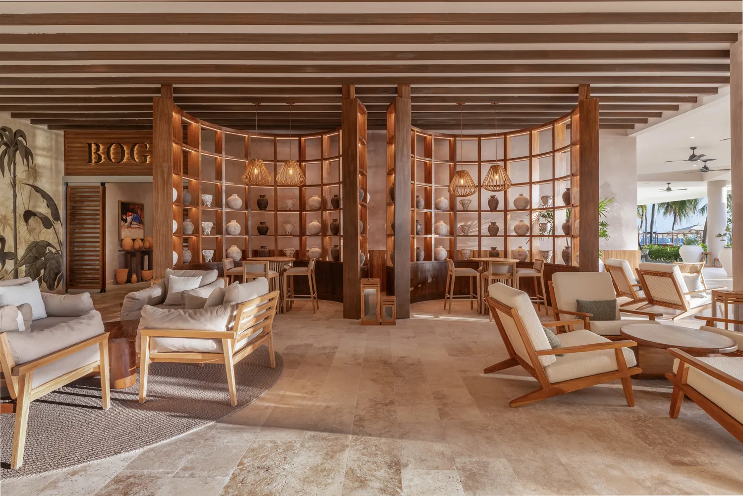 Elegant lounge area at Almare Isla Mujeres resort, featuring wood furnishings and decorative pottery.