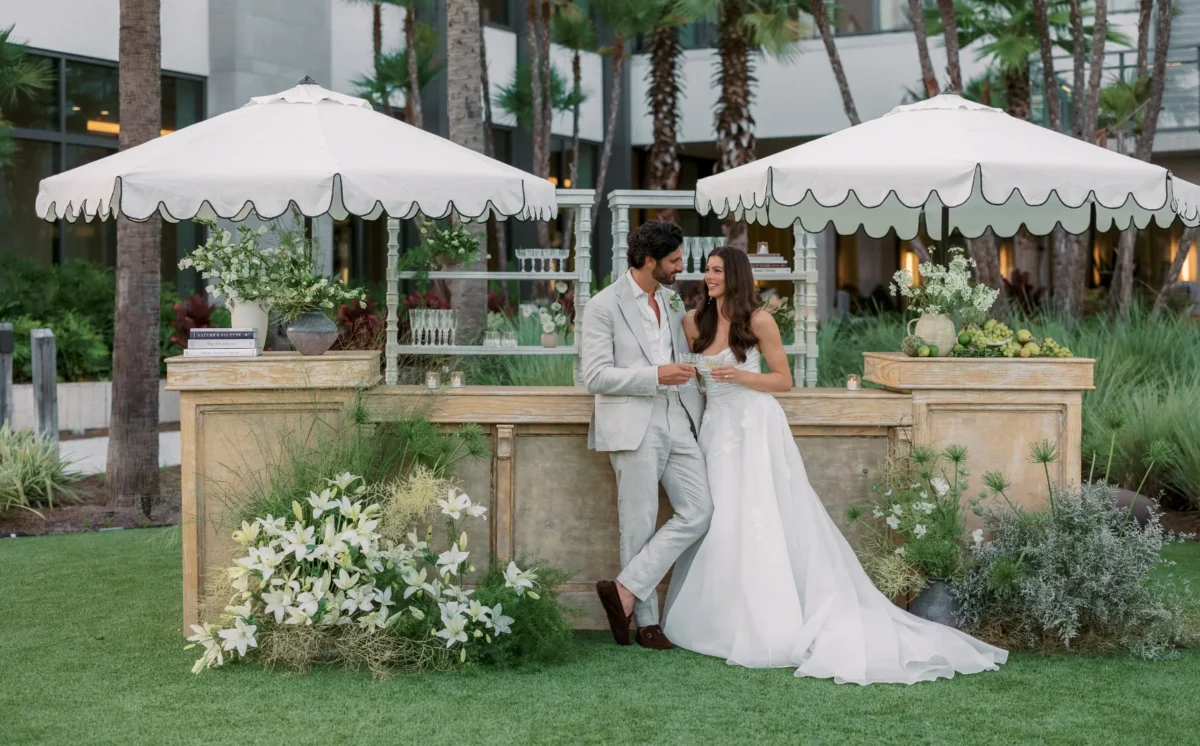 Happy couple toasting at outdoor wedding reception at Conrad Orlando