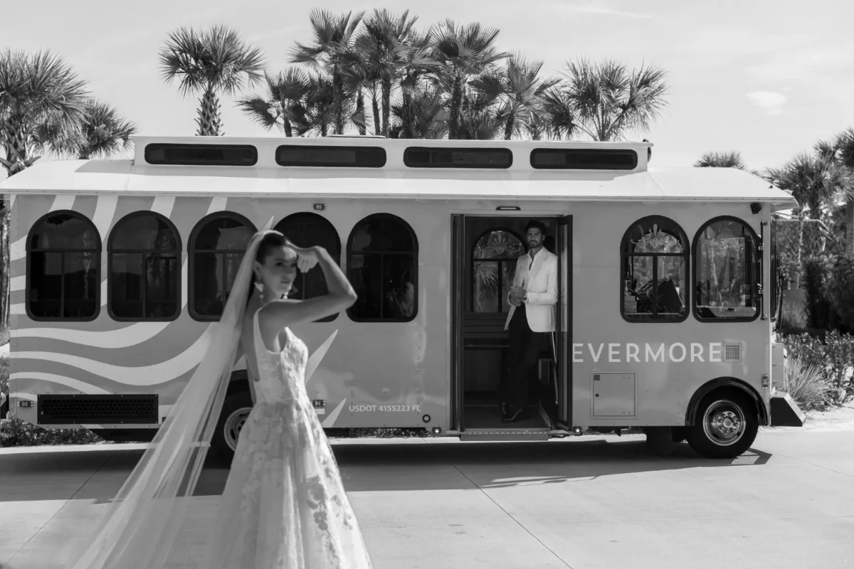 Bride and groom at Conrad Orlando, awaiting transport in a vintage trolley.