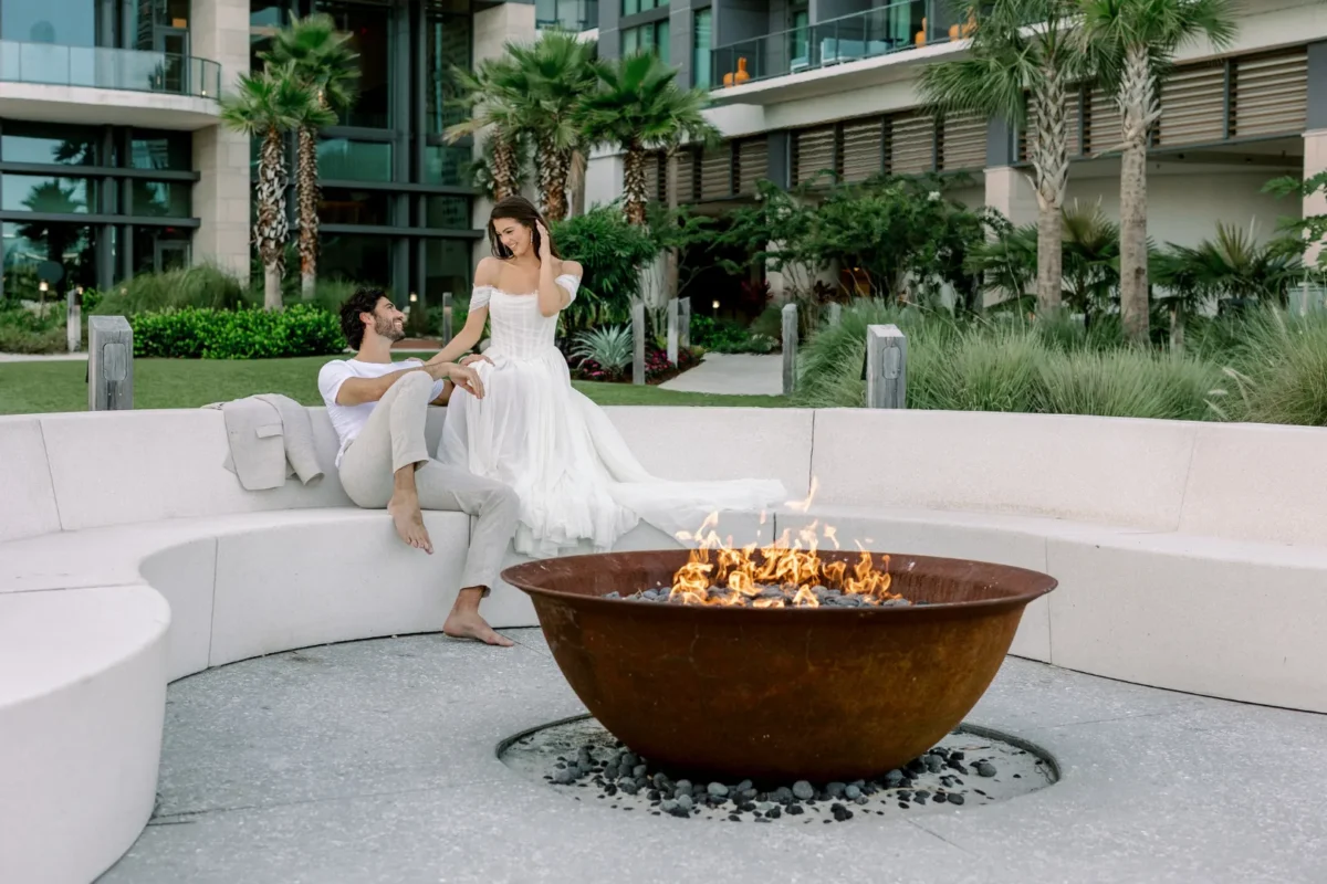Couple relaxing by fire pit at Conrad Orlando