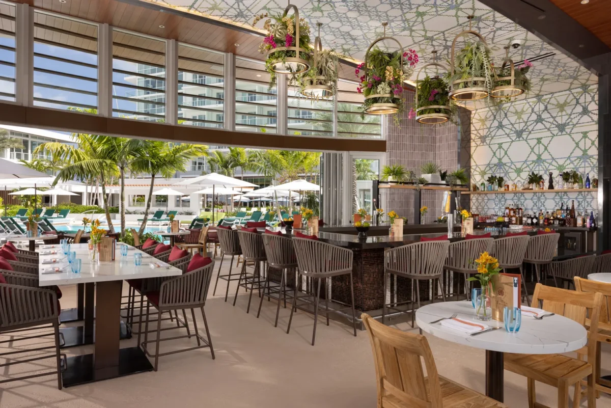 Upscale restaurant with outdoor seating overlooking a pool, perfect for a Fort Lauderdale wedding venue.