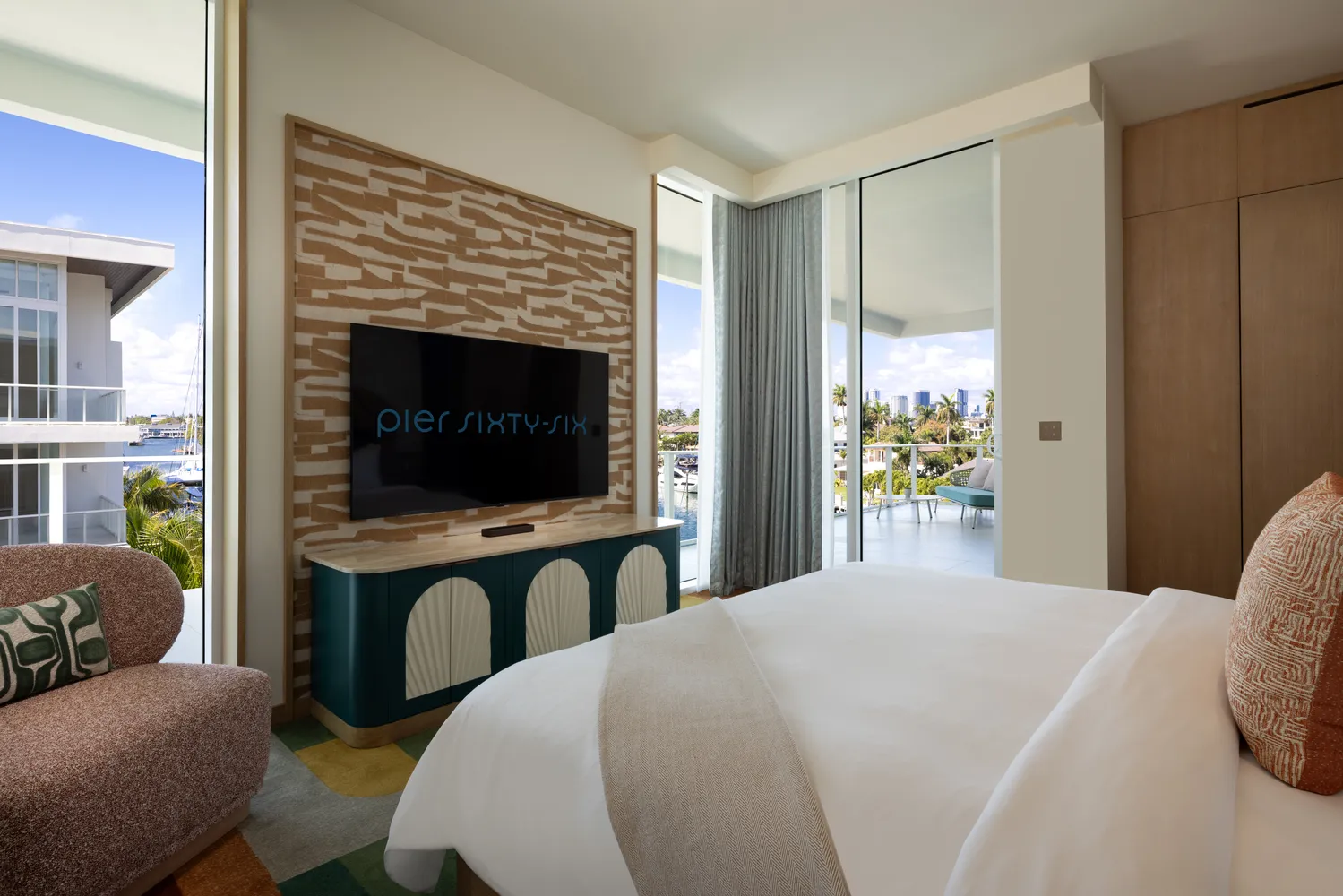 Luxury bedroom at Pier Sixty-Six Fort Lauderdale, featuring a view and TV.