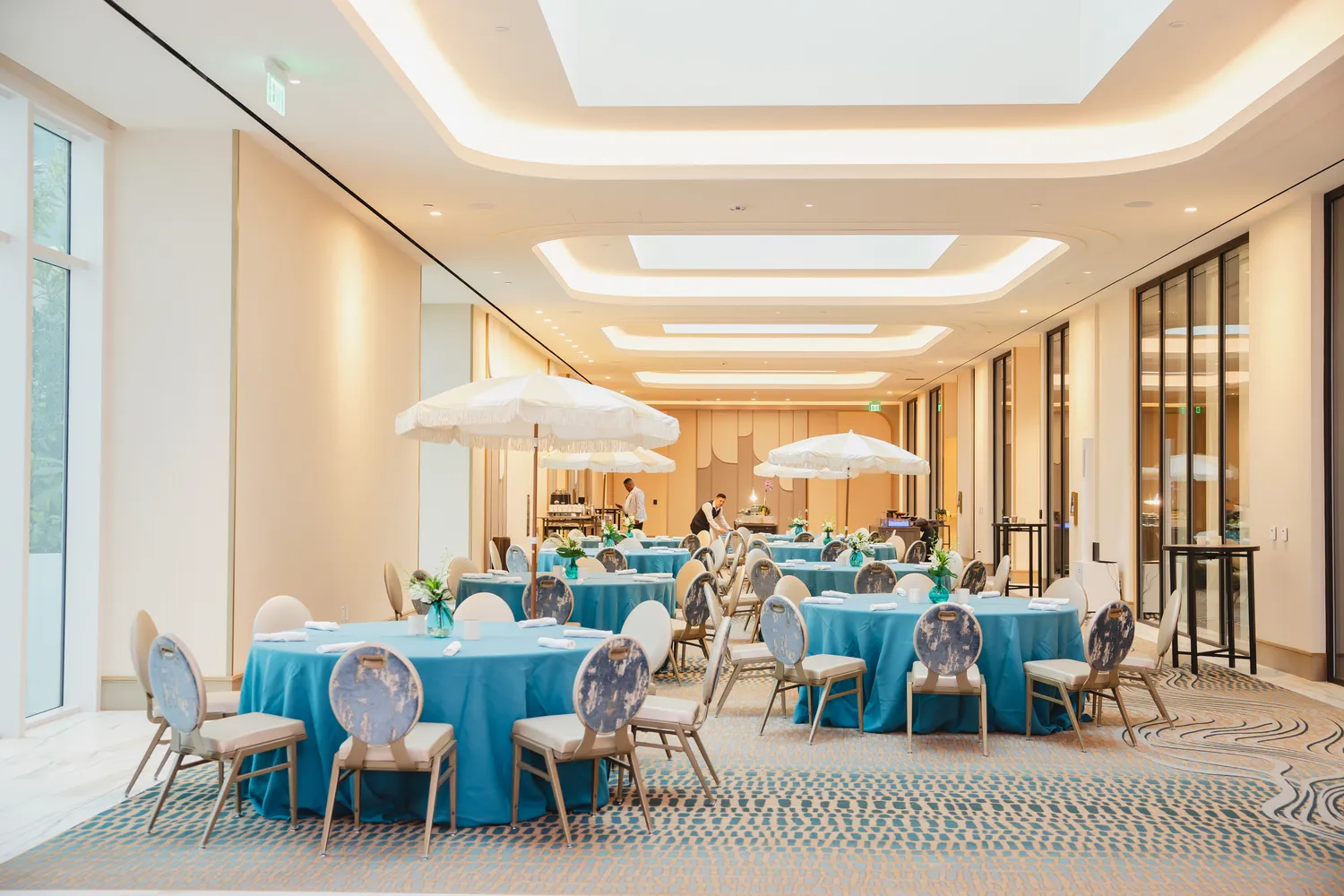 Elegant indoor wedding venue with blue table settings at Pier Sixty-Six, Fort Lauderdale