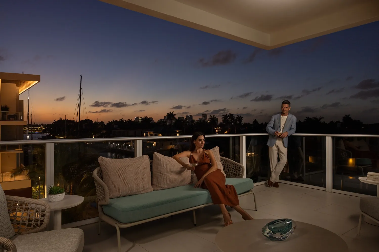 Couple enjoying sunset cocktails on a balcony overlooking Fort Lauderdale.