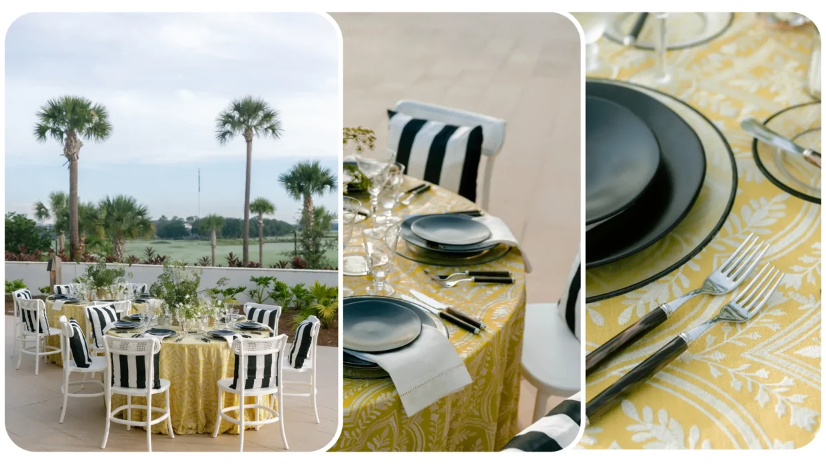 Elegant outdoor dining table set with black plates and yellow tablecloth. Chairs have black and white striped cushions.