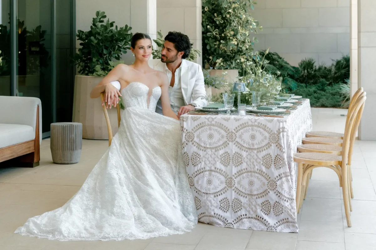 Bride and groom seated at a table at the Conrad Orlando, enjoying a romantic moment.